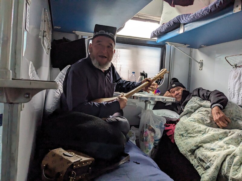 The train slowly pulled into Bukhara as the old man enticed everyone with his two-string guitar and magical voice.