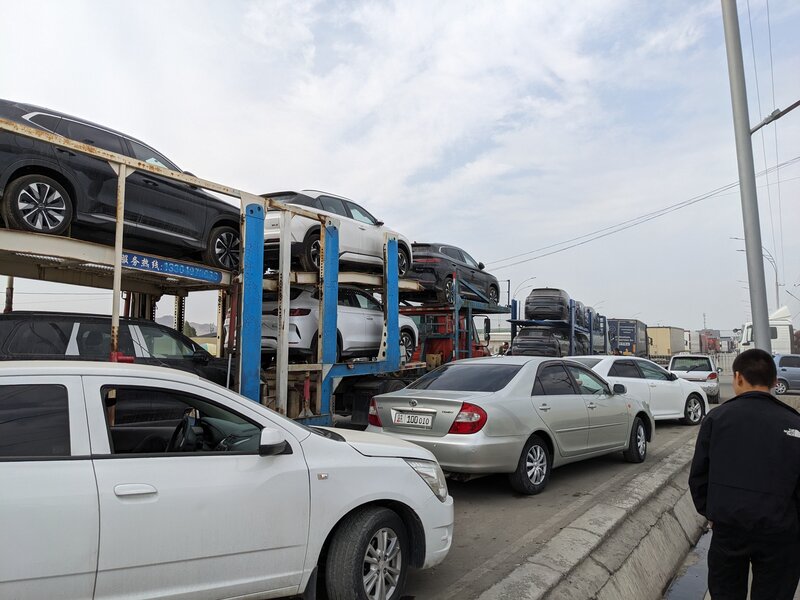 As the endless line of trucks slowly crawled toward Uzbekistan, the air reverberated with dust and fumes.