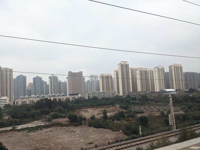 Brutal concrete high-rises under polluted sky