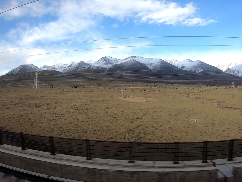 The train dashed through the snow-covered mountains of Western China.